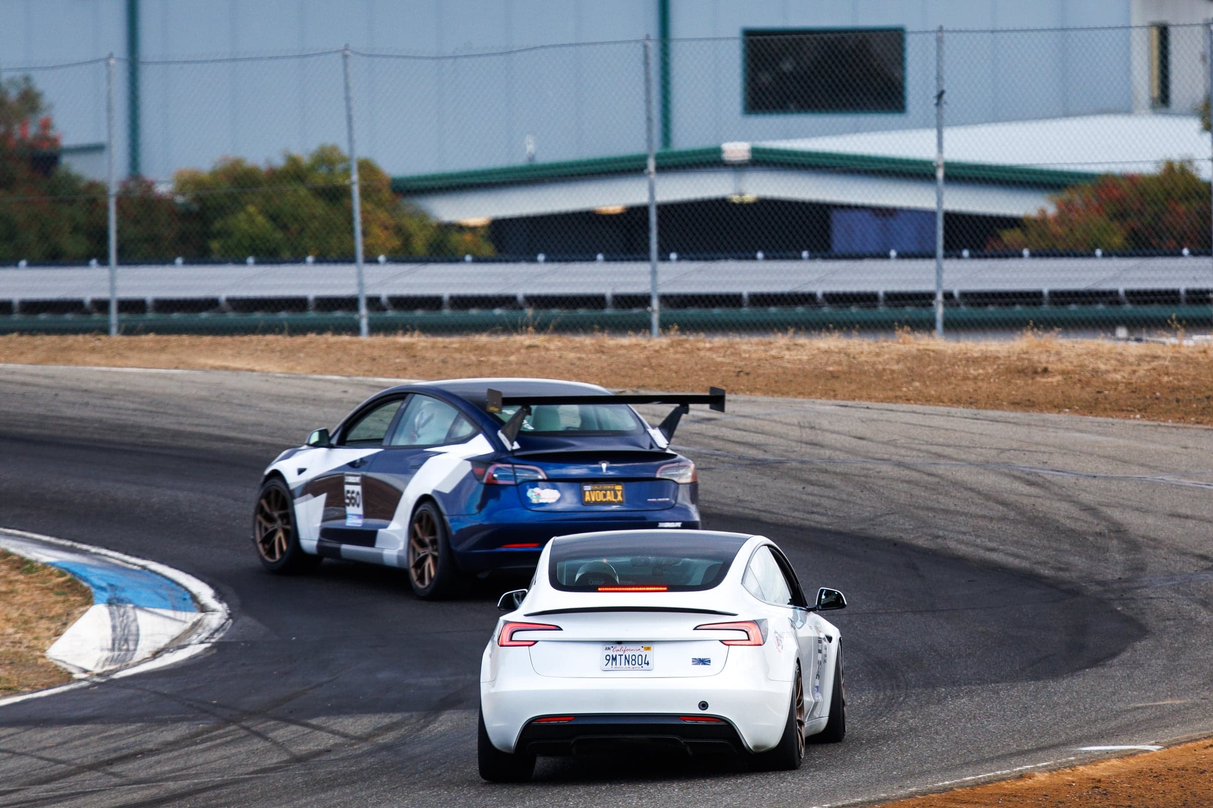 Model 3 Performance chasing a winged Tesla through a hairpin